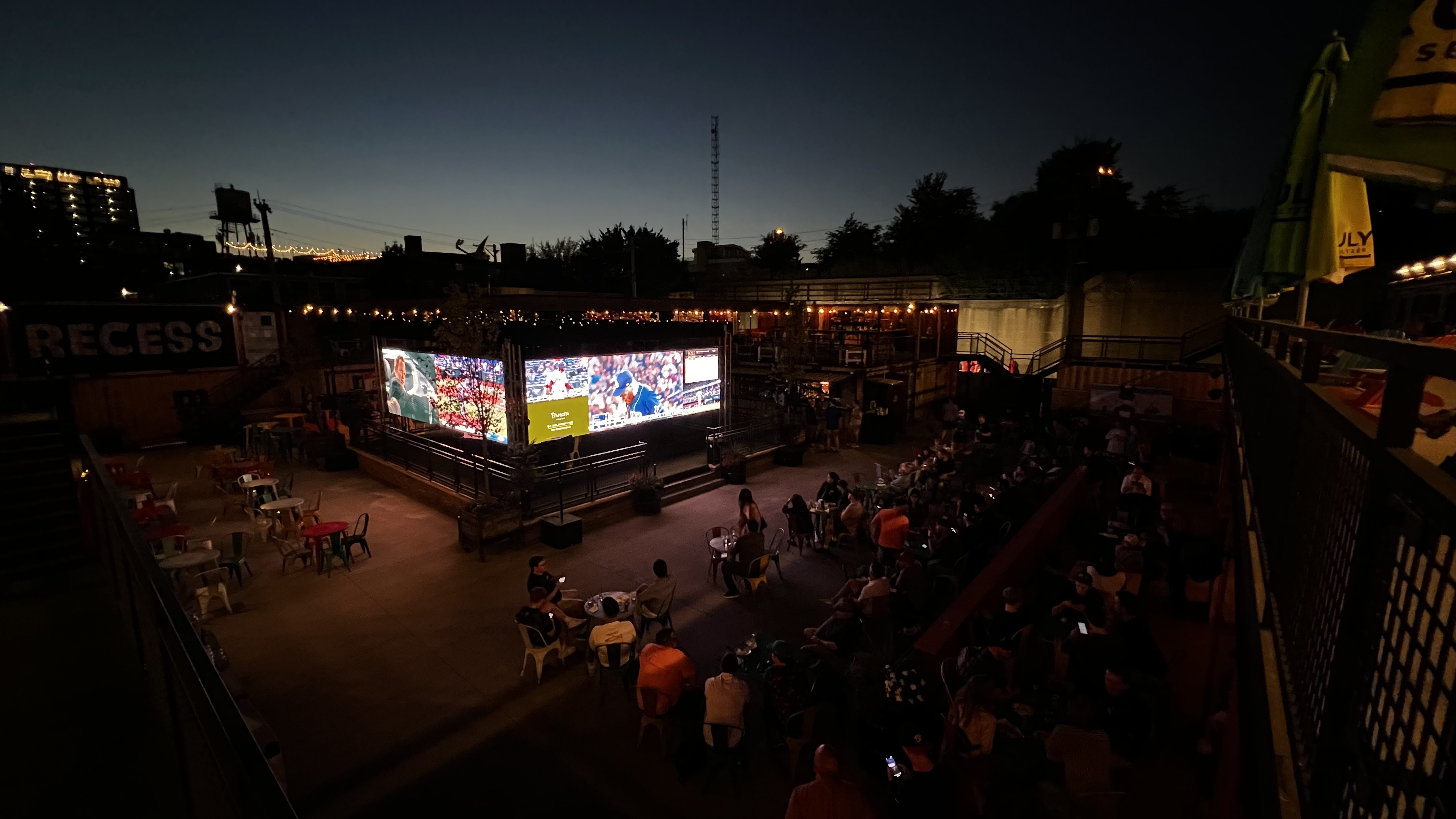 Final FanDuel cube result with screens lit up at night around a crowd.